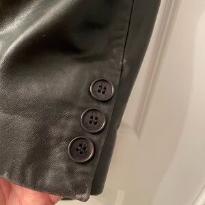 Kenneth Cole Women’s black leather 3/4 length jacket. Excellent condition.